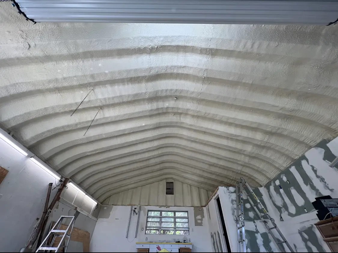 Spray polyurethane foam applied to the underside of a metal roof deck in Flushing
